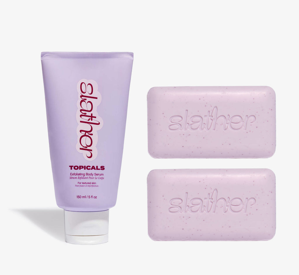 Exfoliating body care bundle from Topicals Slather featuring a lavender 150ml Exfoliating Body Serum tube alongside two pink Slather exfoliating cleansing bars on a white background.