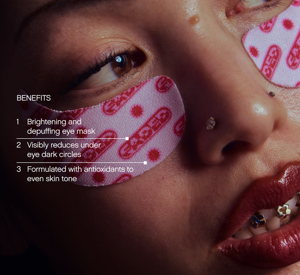 Under eye brightening patches from Topicals Faded shown applied beneath a model's eye, with callouts highlighting benefits including depuffing, reducing dark circles, and evening skin tone.