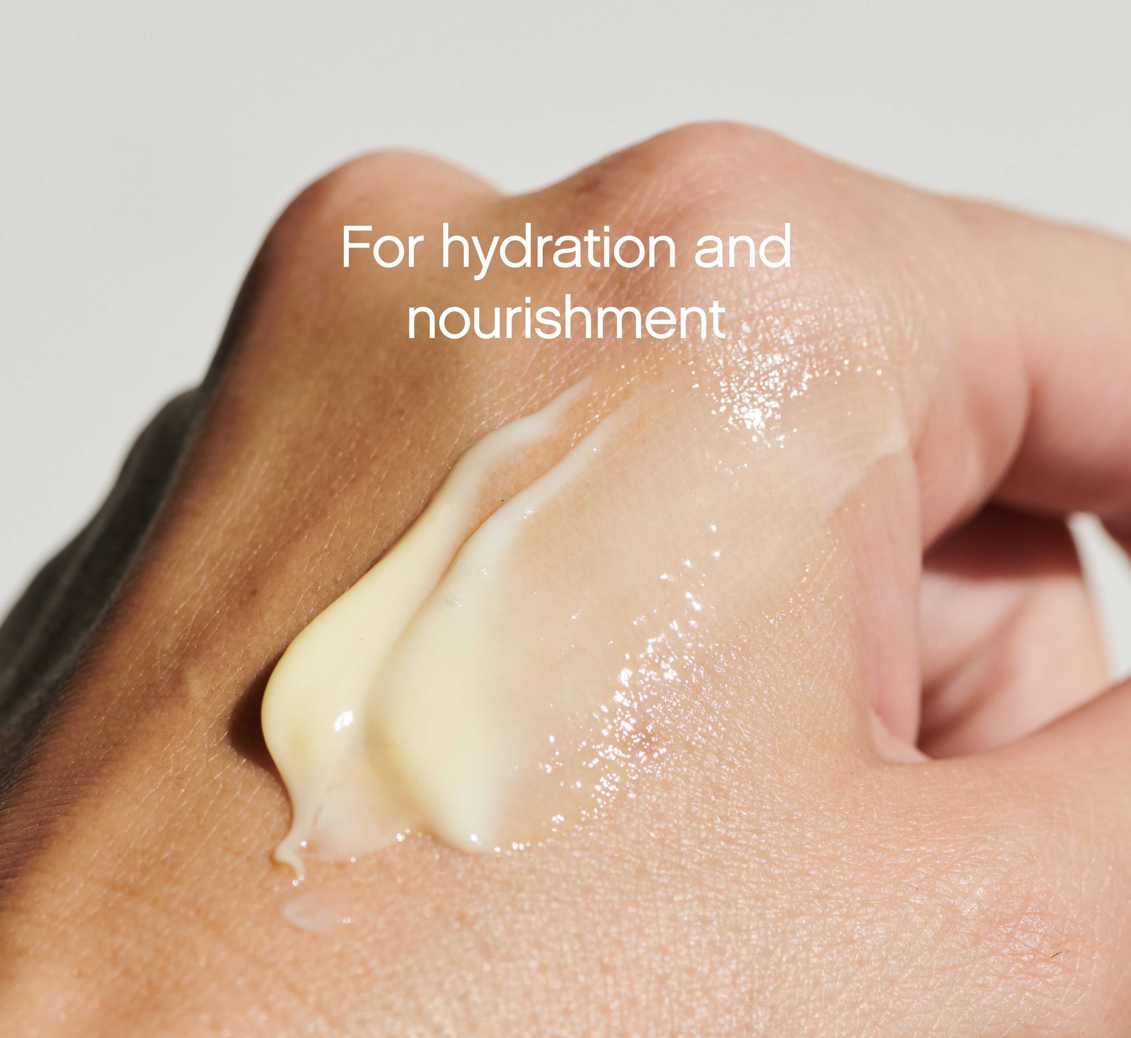 Cream-yellow swatch of Topicals Like Butter moisturizer smeared across the back of a hand to show its hydrating, nourishing texture.