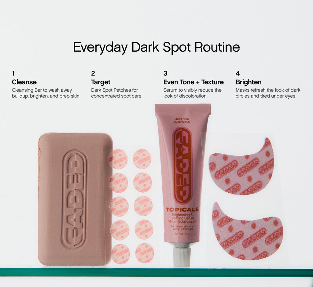 Skincare for dark spots presented as a four-step Topicals Faded routine displaying a cleansing bar, dark spot patches, brightening serum, and under-eye masks on a glass shelf.